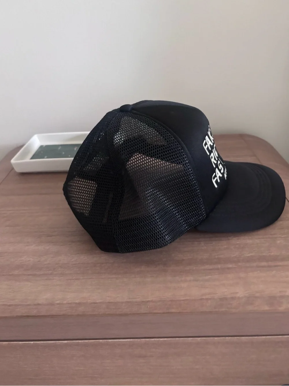 Black Trucker hat with White Embroidery. Homme + Femme “fake love”